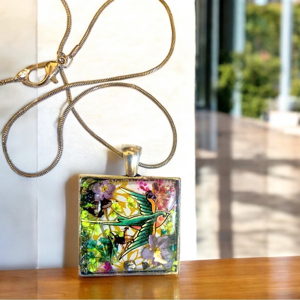 Floral necklace with image of a swallow and real preserved flowers in resin
